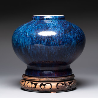 A Chinese flambé-glazed vase on wooden stand, 19th C.