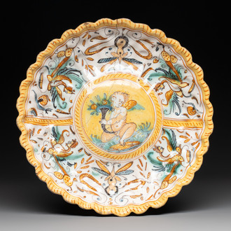 A polychrome Italian maiolica plate with a putto, Deruta, 17th C.