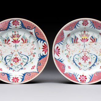 A pair of Chinese famille rose 'winged putti' plates, Yongzheng/Qianlong