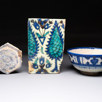A polychrome Damascus tile, a Persian hexagonal tile and a blue-glazed bowl, 17/19th C.