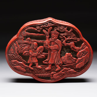 A fine Chinese red cinnabar lacquer ruyi-form 'Ba Man Xian Bao 八蠻獻寶' box and cover, Qianlong