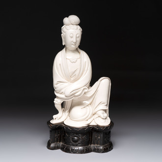 A rare and elegant Chinese Dehua blanc de Chine Guanyin on a wooden stand, Transitional period