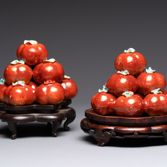 A pair of Chinese polychrome 'persimmons' groups on wooden stands, 19th C.