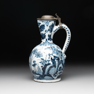 A blue and white Dutch Delft ewer with a mounted pewter lid, 17th C.