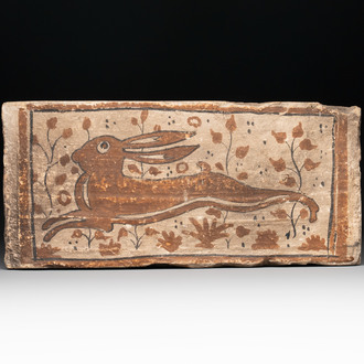 A Spanish cold-painted 'socarrat' or ceiling tile with a hare, 15th C.
