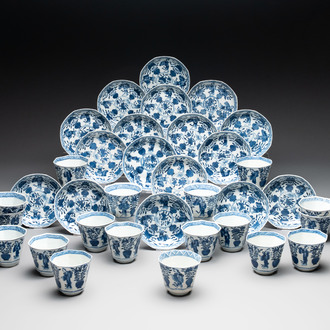 A collection of 18 Japanese blue and white cups and 17 saucers with figural and floral design, 19th C.