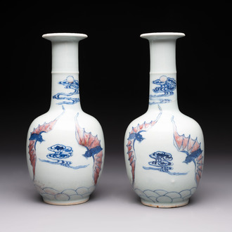 A pair of Chinese blue, white and copper-red 'bats among the clouds' vases, 19th C.