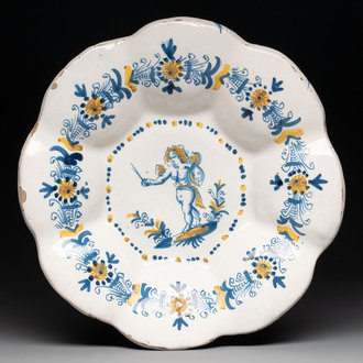 A blue, white and yellow Dutch Delftware dish with a putto, Delft or Haarlem, 17th C.