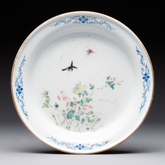 A Chinese famille rose plate with a bird and butterfly among blossoming branches, Yongzheng mark, Republic