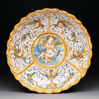 A polychrome Italian maiolica crespina with a putto on a dolphin, Deruta, 17th C.