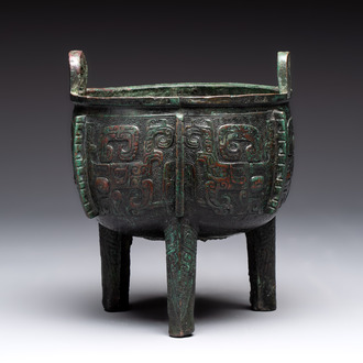 A Chinese archaic bronze tripod food vessel with 'taotie' design, 'ding 鼎', Western Zhou