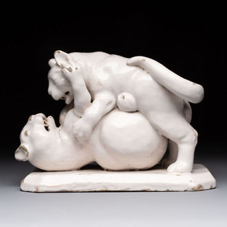 A rare white-glazed Delftware group of two fighting felines, early 18th C.