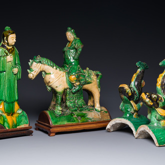 A pair of Chinese sancai-glazed roof tiles in the shape of fish, a warrior on horseback and a sage, Ming