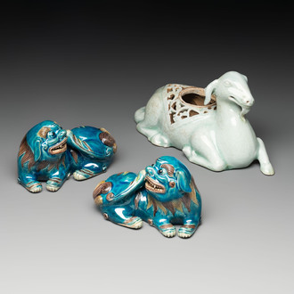 A pair of Chinese polychrome lions and a celadon-glazed goat, 20th C.