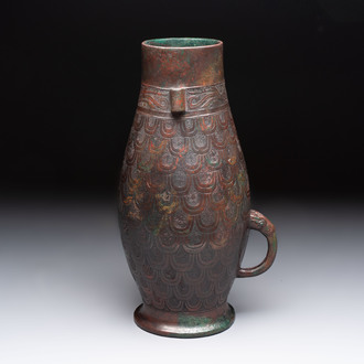 A Chinese archaic bronze wine vessel with scale design, 'hu 壺', Zhou