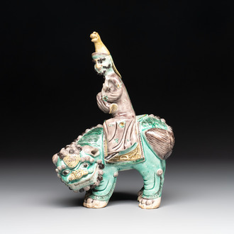 A Chinese verte biscuit 'Sogdian riding a Buddhist lion' group, 19th C.