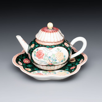 A Chinese famille rose black-ground teapot and stand with floral design, Yongzheng/Qianlong