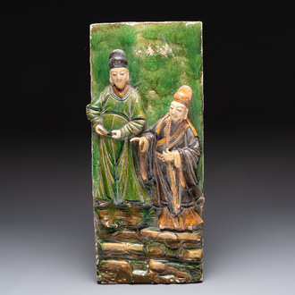 A large Chinese sancai-glazed architectural tile with two figures, Ming