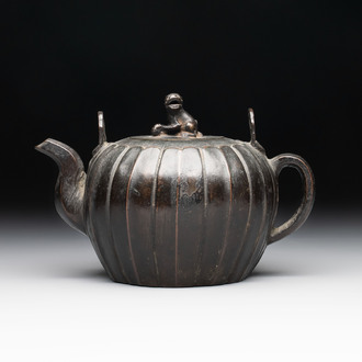 A Chinese bronze teapot and cover with a lion-shaped finial, Yuan