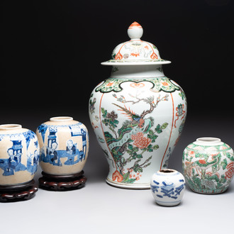 A Chinese famille verte covered vase, a pair of blue and white jars on wooden stands and two jars, 19th C.