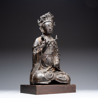 A large Chinese bronze Bodhisattva on wooden stand, Ming