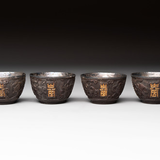 Four Chinese carved and silver-lined coconut cups, 19/20th C.