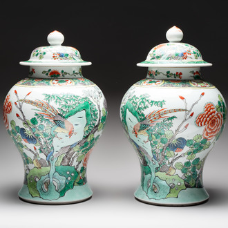 A pair of Chinese famille verte 'birds and flowers' vases and covers, 19th C.