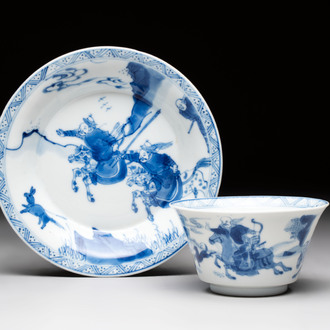 A Chinese blue and white 'Mongolian hunting' cup and saucer, jade mark, Kangxi