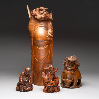Three Chinese carved bamboo figures and a boxwood carving of a phoenix, 20th C.