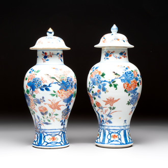 A pair of Chinese verte-Imari 'birds among flowering branches' vases and covers, Kangxi
