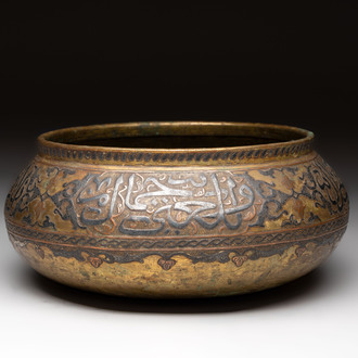 A Persian silver- and copper-inlaid 'calligraphic' brass bowl, 18th C.
