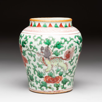 A small Chinese wucai 'Buddhist lion and peony scrolls' jar, Transitional period