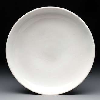 A Chinese Dehua blanc de Chine incised 'peony' plate, 17/18th C.