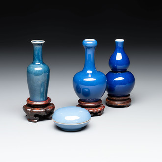 Three Chinese blue-glazed miniature vases on wooden stands and a claire-de-lune seal paste box and cover, 19th C.