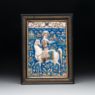 A rectangular Qajar relief-moulded tile with a falconer on horseback, Iran, 19th C.