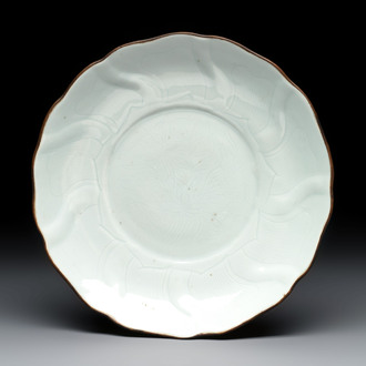 A Chinese moulded white-glazed plate with anhua floral design, Xuande mark, Ming