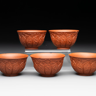 A set of five Chinese Yixing stoneware cups with floral design, Kangxi