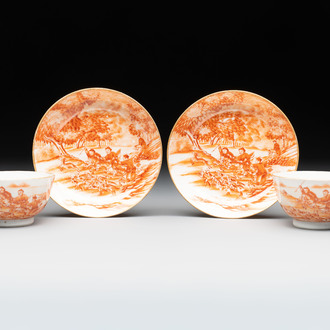 A pair of Chinese iron-red-decorated 'deer hunting' cups and saucers, Qianlong