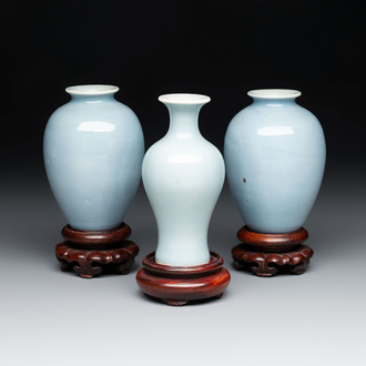 Three Chinese claire-de-lune vases on wooden stands, Kangxi mark, 19th C.