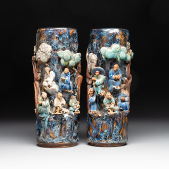 A pair of Chinese Shiwan polychrome hat stands with haut-relief figural design, 19/20th C.