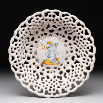 A reticulated Italian blue, white and yellow 'putto' tazza, Faenza, 17th C.