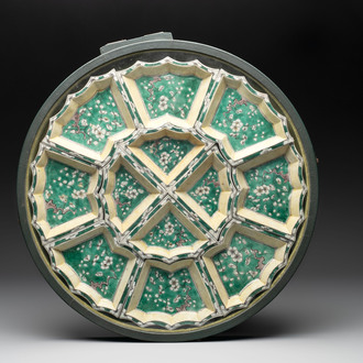 A Chinese verte biscuit 12-piece 'plum blossoms' sweetmeat set in a case, Kangxi
