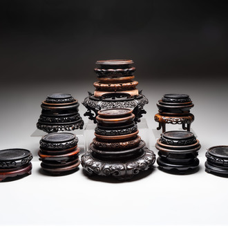 A collection of 25 Chinese wooden stands, 19/20th C.