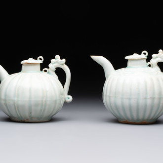 A pair of Chinese qingbai ewers and covers with dragon-form handles, Song/Yuan