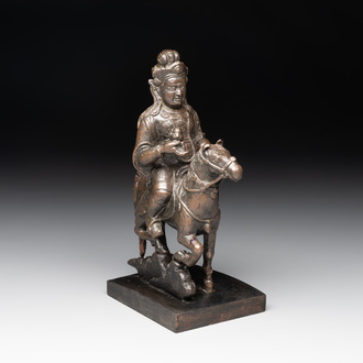 A rare Chinese bronze Vaishravana on horseback with wooden stand, Yuan