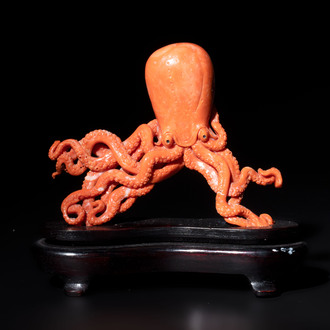 A Japanese red coral sculpture of an octopus on wooden stand, 19/20th C.