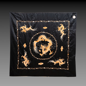 A Chinese black-ground embroidered silk panel with a four-clawed dragon, 19th C.