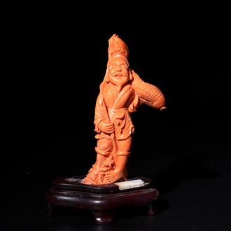 A Japanese red coral sculpture of a fisherman on wooden stand, 19/20th C.