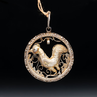 A gilt-brass 'Rooster' amulet with glass-inlaid eyes, 17th C. or later