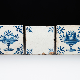 A rare 'empty' blue and white Dutch Delft tile and two 'fruit bowl' tiles, 17th C.